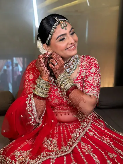 A classic bridal bun adorned with fresh white flowers. This hairstyle is perfect for a traditional Phera ceremony, offering a look of pure elegance.