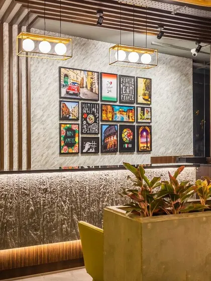 A focused shot of the cash counter, highlighting the material contrast between the monolithic stone-look base and the polished wood fluted panel behind it. This detail exemplifies our approach to creating visual interest through texture and material selection.
