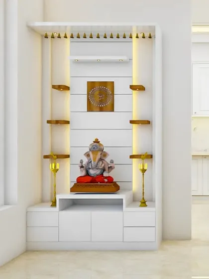A bright and airy pooja unit in white, with wooden shelves and traditional brass lamps. The design is clean and minimalist, making it a perfect fit for a modern home.