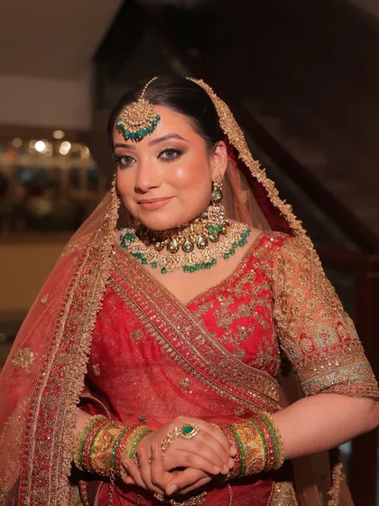 A full bridal look featuring a red lehenga with green-accented kundan jewellery. These images show how you can create a perfectly coordinated and stunning bridal look through my rental service.