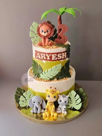 Repeating one of my favorite jungle designs for Aryesh's third birthday. This two-tier red velvet cake is adorned with detailed, hand-sculpted safari animals and tropical leaves.