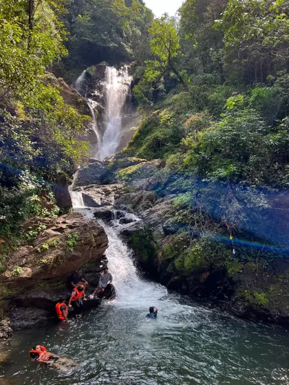 A hidden waterfall near Gokarna where the team can cool off. My itineraries include exploring these less-known natural gems.