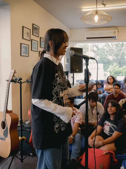 A student sharing her thoughts with the audience. We encourage our performers to connect with the crowd and share the story behind their music.