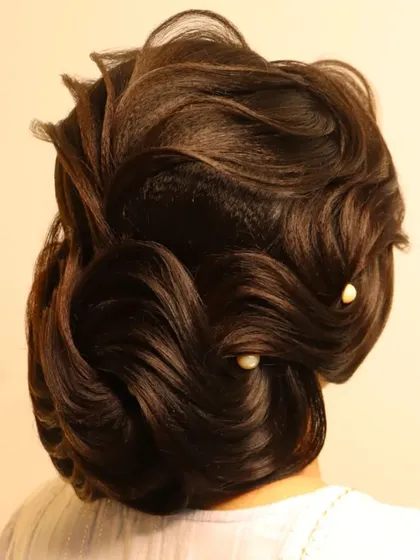 An elegant S-waves bun, perfect for a wedding day. This style is all about creating sleek, chic, and graceful lines in the hair.