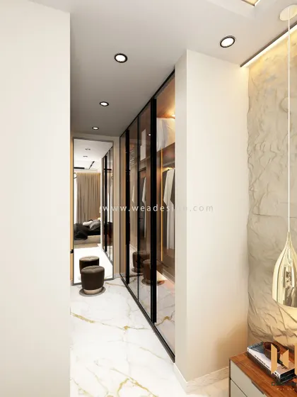 A view of the walk-in closet from the bedroom, showing how the tinted glass doors create a sense of depth and luxury.