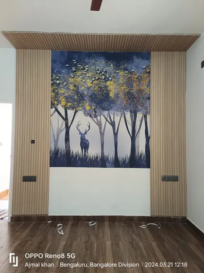 A custom wallpaper mural featuring a deer in a forest, framed by fluted wall panels. This combination of textures creates a sophisticated and modern feature wall.