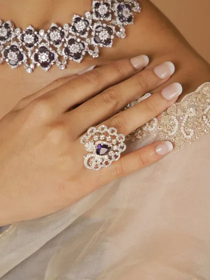 A close-up of the statement ring from our new polki diamond collection. The intricate design and deep purple stone make it a standout piece.
