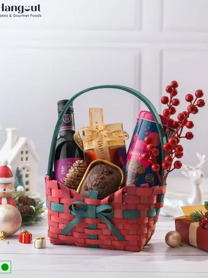 Spread festive cheer with the Joyful Jubilee Christmas Hamper. This classic red and green basket is filled with a plum cake, ginger cookies, a cookie tin, and a bottle of alcohol-free wine.