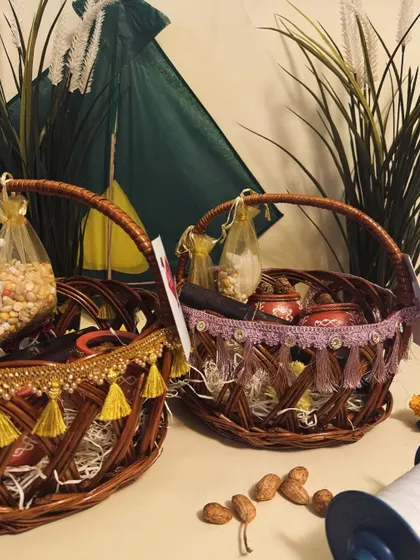 Our traditional Sankranti hampers in decorated wicker baskets. They are packed with tilgul, sweets, and peanuts, perfect for gifting.