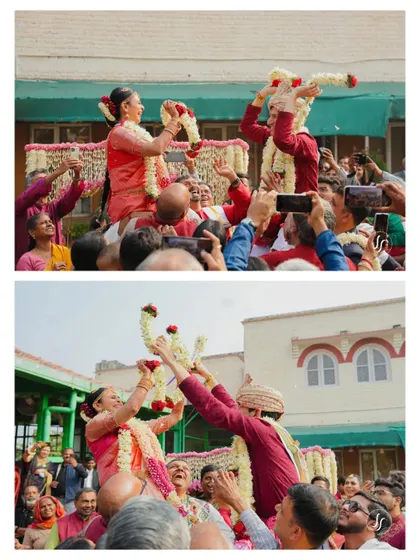 The fun and excitement of the Jaimala ceremony, with the bride and groom lifted up by their families for the playful exchange.