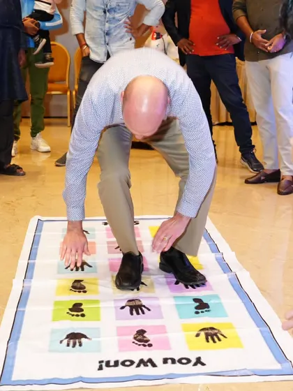 A guest takes on the challenge of the hands and feet mat game.
