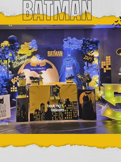 We transformed the party space into Gotham City for Rudraksh's fifth birthday. This Batman theme featured a city skyline, the Bat-Signal, and a dark and moody color palette of black, yellow, and blue balloons.