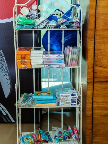 A shelf filled with return gifts and prizes, showcasing the variety of party favors we can arrange for your event.