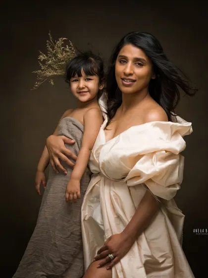 A beautiful mother-daughter portrait with a fine art aesthetic. The rich tones and their gentle connection make this a truly special image.