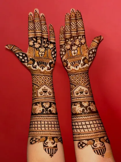 A grand and traditional bridal design, featuring various symbolic motifs like peacocks, elephants, and kalash.