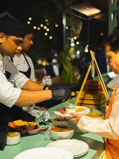 A chef at our live Mexican station serves a guest freshly made guacamole and salsas.