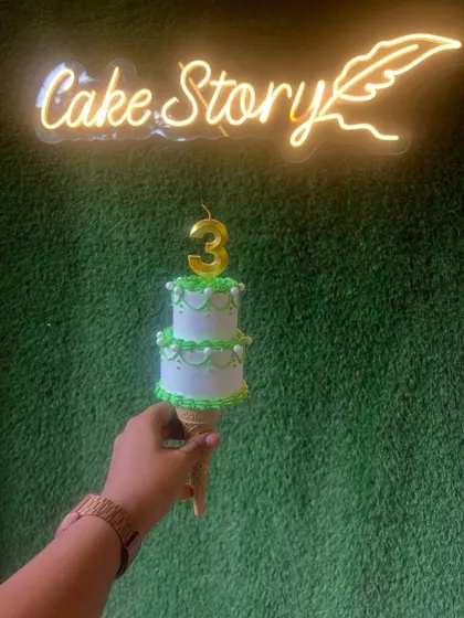 The trending cone cake! A mini two-tier cake served on an ice cream cone, perfect for a unique and individual treat.