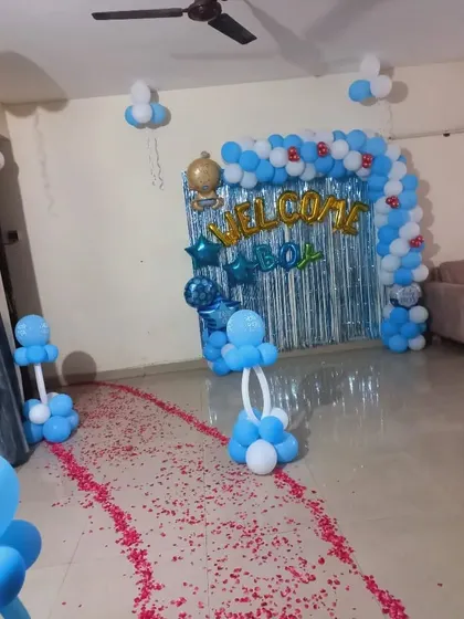 A full view of a 'Welcome Boy' home decoration, showing the petal-strewn path leading to the main balloon backdrop.
