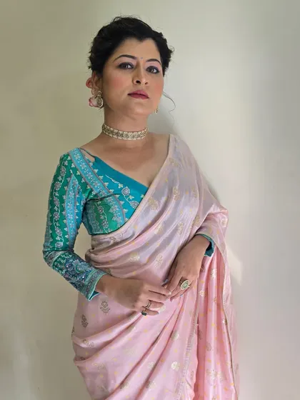 A confident portrait showing the unique color combination of the outfit. The makeup is kept soft and sophisticated to complement the look.