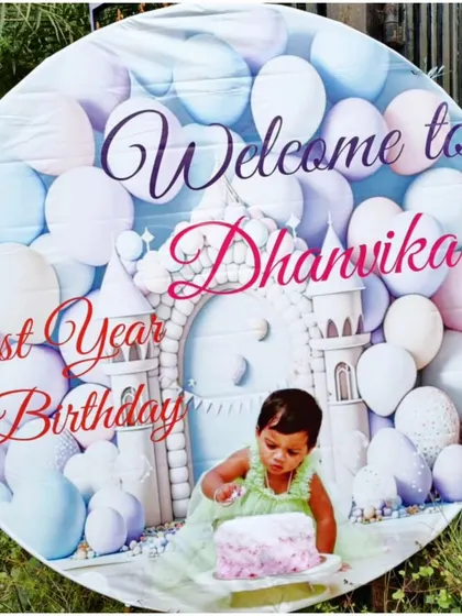 A custom circular welcome banner for a first birthday party, featuring a photo of the birthday girl.