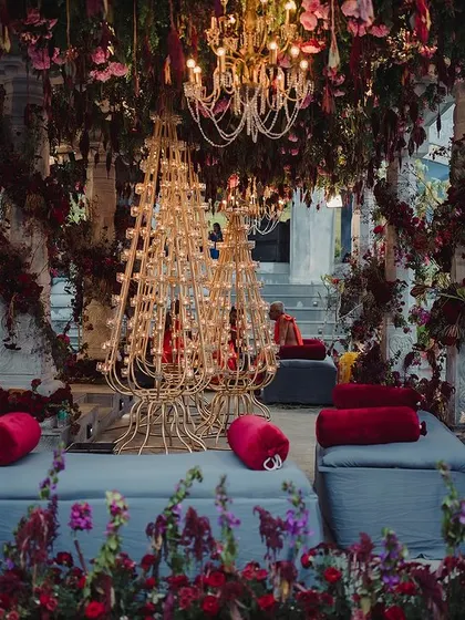 The lounge seating area for a traditional ceremony, surrounded by our elaborate floral decor. This shot captures the calm before the guests arrive, showing the intricate details like the custom candle stands and lush floor arrangements.
