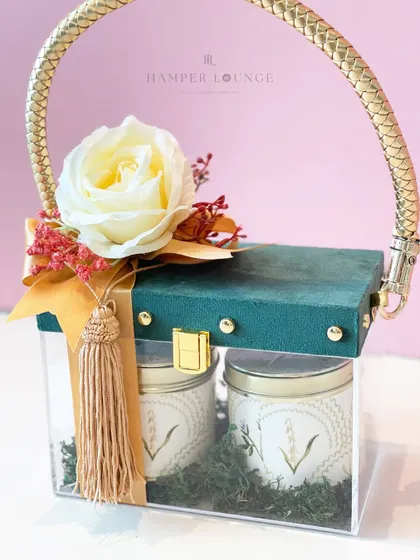 Celebrate Eid with a gift that stands out. This elegant glass bag with a gold handle is filled with scented candles and festive treats, making it a beautiful and modern Eidi for your loved ones.