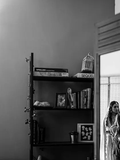 A fly-on-the-wall perspective of the bride getting ready, reflected in a mirror.