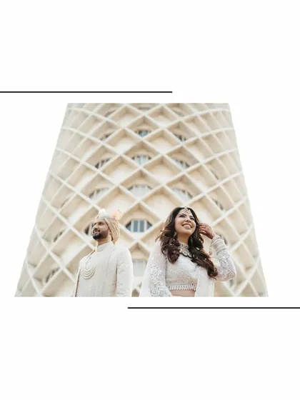 A modern and architectural couple portrait. The clean lines of the building contrast beautifully with the soft elegance of the bride and groom's traditional attire.