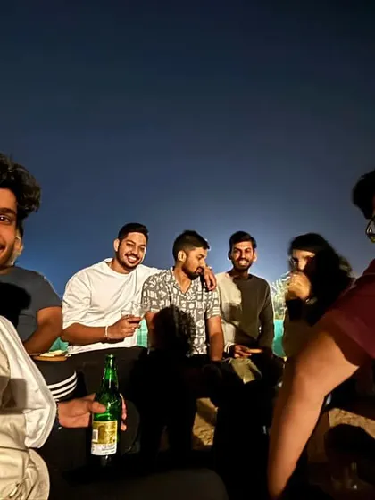 A candid selfie of friends enjoying a drink at night during the trip. These are the relaxed, fun moments that define our travel experience.