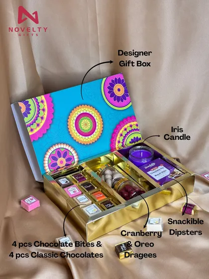 This vibrant hamper is packed with treats. It includes assorted chocolates, cranberry dipsters, Oreo dragees, and an Iris candle, all in a designer gift box.