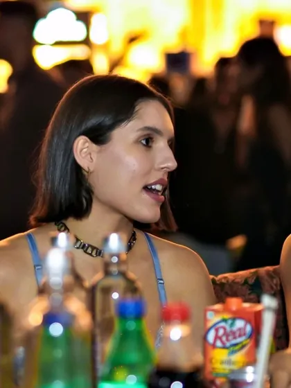 A candid shot of a guest at her table, engaged in the lively atmosphere.