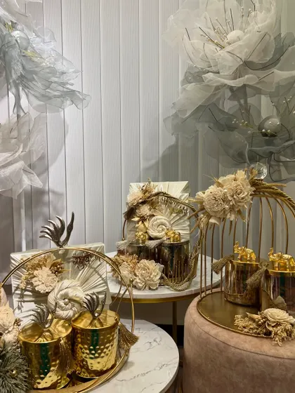 A showcase of our elegant and modern Rakhi hampers. This collection uses a sophisticated palette of gold and cream, with intricate floral details and stylish birdcage props for a luxurious feel.