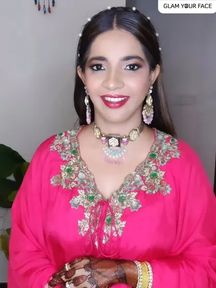A happy and confident bride ready for her event. This glam look, featuring a bright pink outfit and complementary makeup, shows how we can create a cohesive and stunning style.
