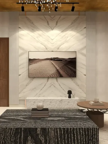 The TV wall in the Noida penthouse living room is clad in book-matched marble, creating a seamless and luxurious focal point.