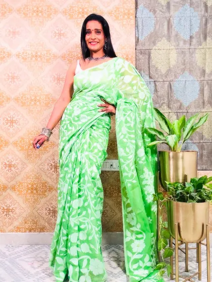 A fresh green Jamdani saree with white floral weaving. This is a very pretty and elegant saree, perfect for a daytime event.
