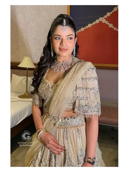 Another view of Shreya's elegant reception look. The soft lighting in this shot highlights the subtle glow and dimension we created on her skin.