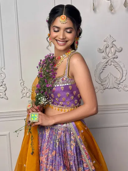 Flowers and a smile. This image perfectly captures the joyful and fresh essence of the 'Khushnuma' look, ideal for a daytime wedding event.