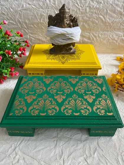 These yellow and green pooja chowkis are perfect for placing your idols during prayers. The intricate stenciling adds a touch of elegance.