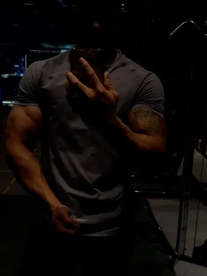 A moody, shadowed shot that still reveals the underlying muscle and form.