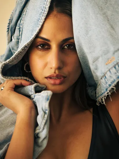 A close-up portrait using the denim jacket to frame the face. It's a creative twist on a standard headshot.