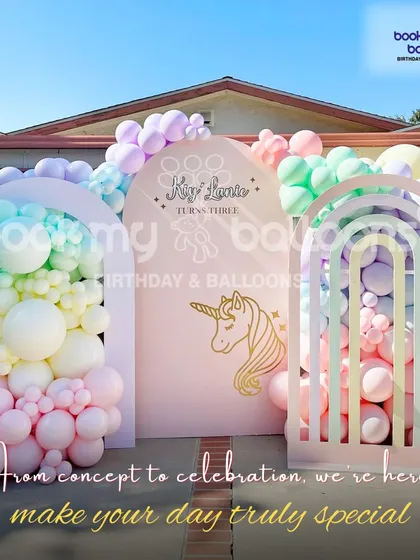 This pastel rainbow unicorn theme shows how we can transform an outdoor space. The setup features multiple arched backdrops and a cascade of soft colored balloons, creating a magical and dreamy entrance for a third birthday.