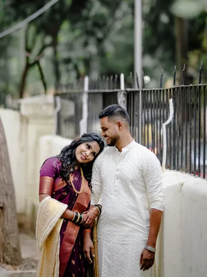A quiet, tender moment outdoors. The bride rests her head on the groom's shoulder, creating a portrait that is both peaceful and full of emotion.