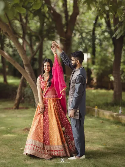 Another beautiful twirl shot from the Roka ceremony. The vibrant colors of the bride's lehenga pop against the natural green background.