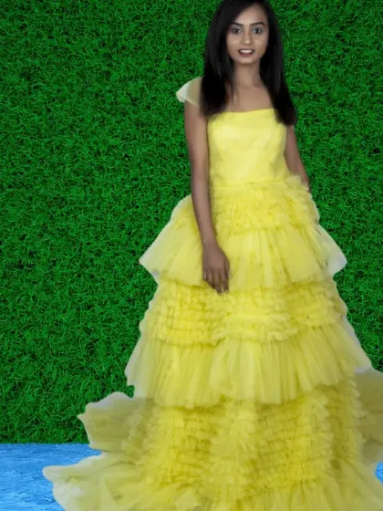 Brighten up your photoshoot with this sunny yellow tiered ruffle gown. It's a cheerful and eye-catching choice that guarantees stunning pictures.