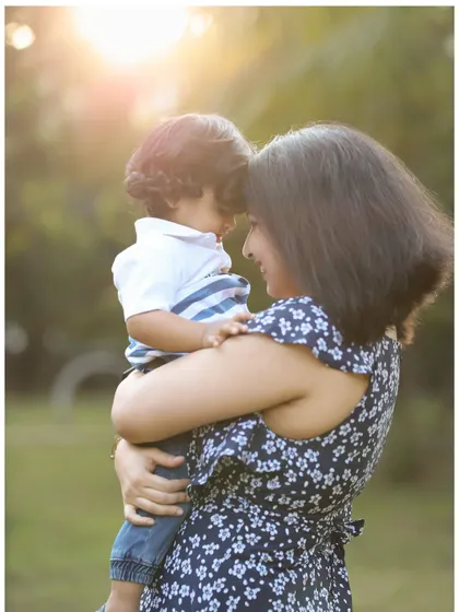 A tender moment between a mother and her child during an outdoor session. This image focuses on the quiet connection and love shared between them.
