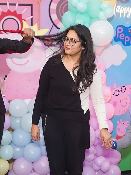 Our entertainment options keep guests of all ages captivated. Here, a professional magician performs an amazing trick, delighting both children and adults during a Peppa Pig themed birthday party.