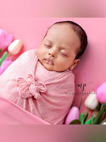 A beautiful portrait of the baby among the tulips.