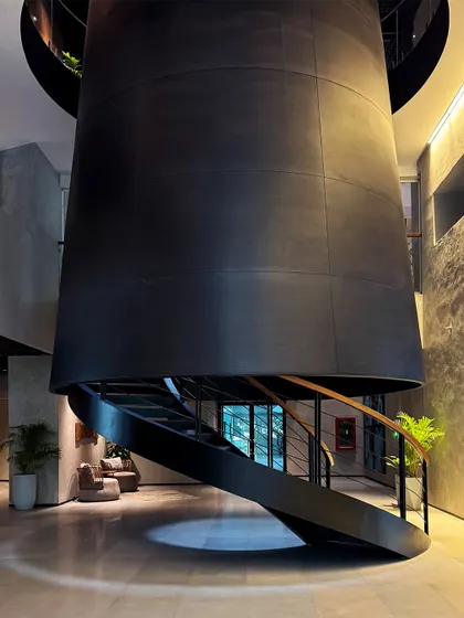 A view of the dramatic, cone-like structure housing the central staircase at BCG HQ, a form that echoes Bombay's industrial heritage.