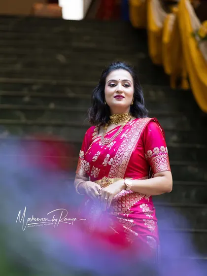 Vaishnavi looking stunning in a bright pink saree. Her hair is styled in modern, loose waves, showing the versatility of styling for traditional wear.
