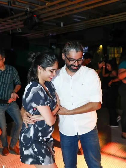 A smiling couple enjoying the rhythm together. The happiness on their faces is a testament to the joy of dance.